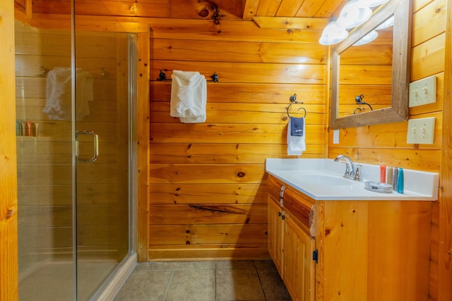 bathroom with tile patterned floors, vanity, wood walls, and walk in shower