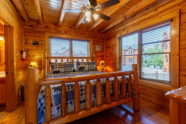 bedroom with ceiling fan, beam ceiling, wooden ceiling, and multiple windows