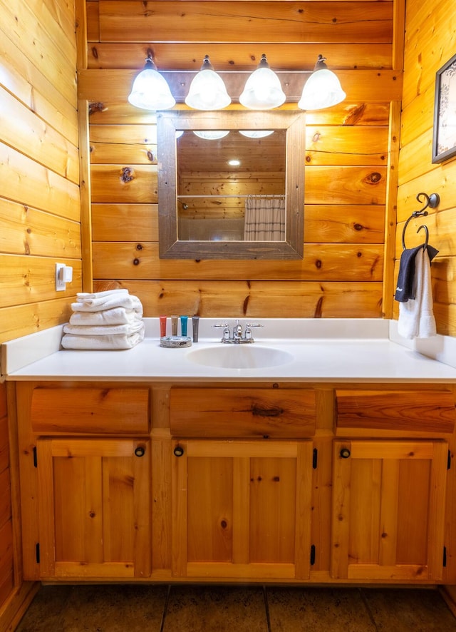 bathroom featuring vanity, tile patterned floors, and wooden walls