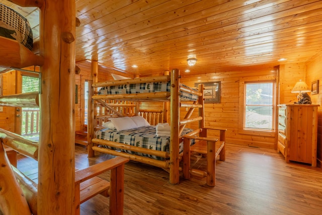 bedroom featuring hardwood / wood-style floors, wood walls, and wood ceiling