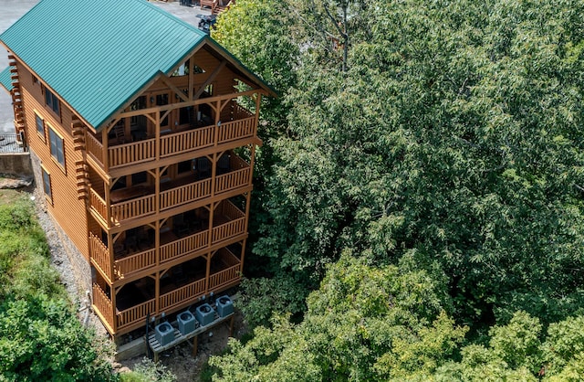 rear view of property featuring a balcony and cooling unit