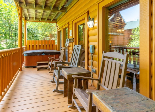 wooden deck with a hot tub