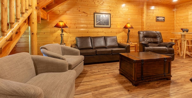 living room with wooden walls and light wood-type flooring