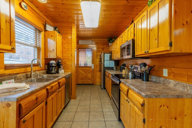 kitchen with sink, wood ceiling, stainless steel appliances, and a wealth of natural light