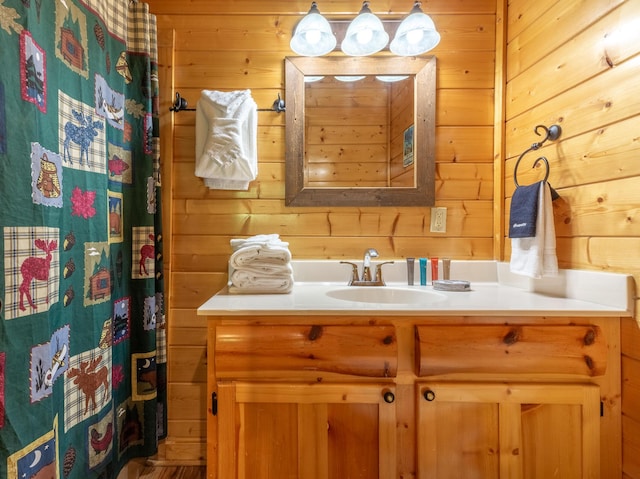 bathroom with wooden walls and vanity