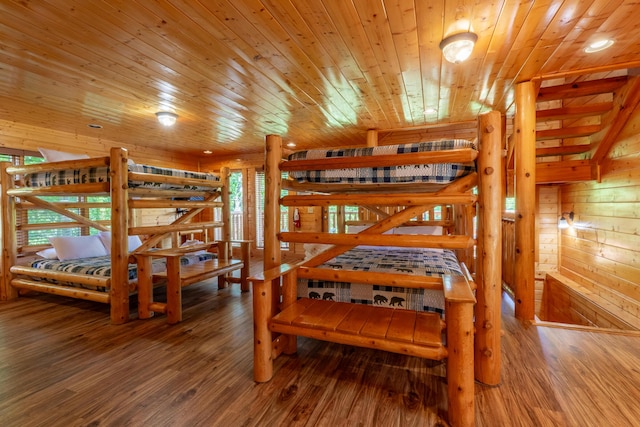 bedroom featuring wood-type flooring, wood ceiling, and wooden walls