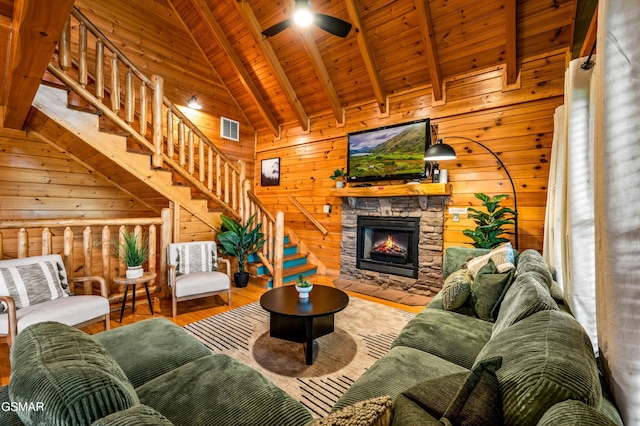 living area featuring visible vents, ceiling fan, wood ceiling, stairs, and wood finished floors