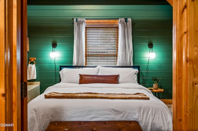 bedroom with wood walls