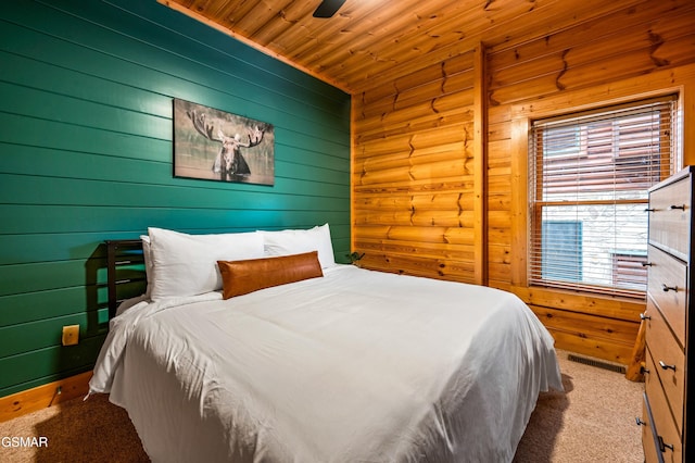 carpeted bedroom with wooden ceiling, a ceiling fan, and visible vents