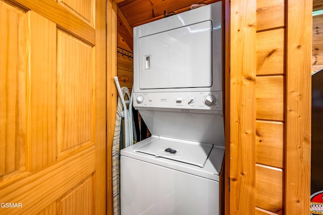 clothes washing area with laundry area and stacked washer / dryer