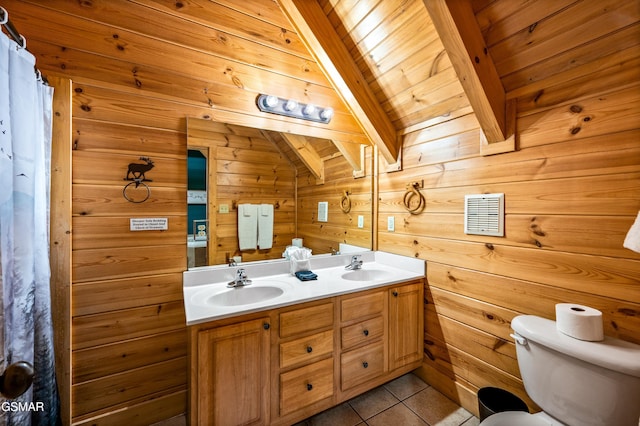 bathroom with tile patterned floors, double vanity, toilet, and a sink