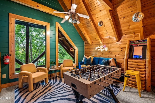 recreation room featuring wooden walls, carpet, wood ceiling, lofted ceiling with beams, and a ceiling fan