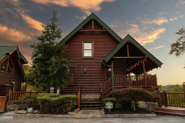 log cabin featuring a deck