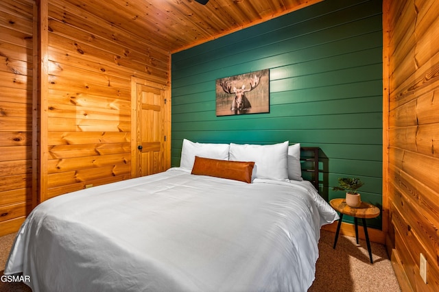 carpeted bedroom featuring wooden ceiling