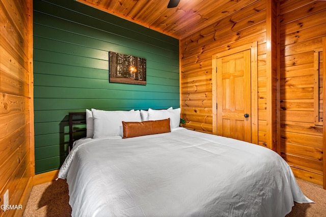 bedroom with wooden ceiling, a ceiling fan, and carpet floors