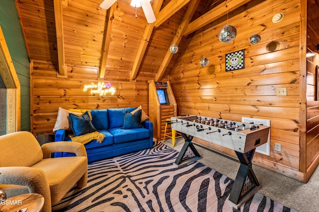 playroom with wooden walls, vaulted ceiling with beams, carpet, wood ceiling, and a ceiling fan