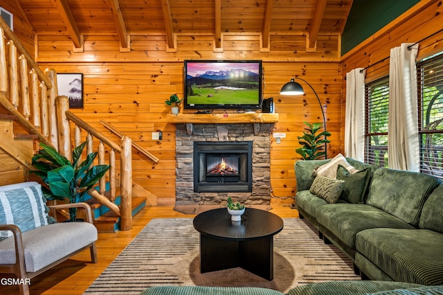 living area featuring wood walls, wooden ceiling, and stairs