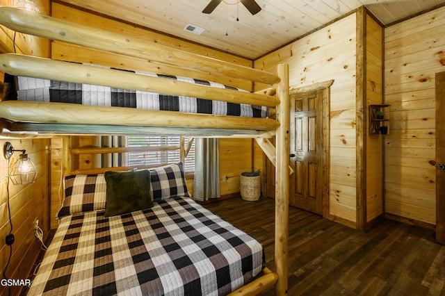 bedroom featuring wooden walls, wooden ceiling, and dark hardwood / wood-style floors