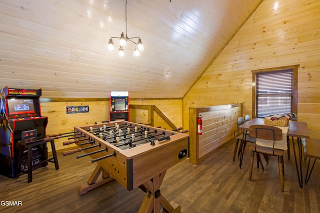 rec room with hardwood / wood-style flooring, lofted ceiling, an inviting chandelier, and wooden walls