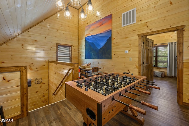 game room featuring dark wood-type flooring, wooden ceiling, a chandelier, and wood walls