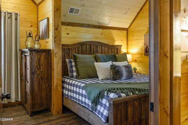 bedroom featuring lofted ceiling, dark wood-type flooring, wooden walls, and wooden ceiling