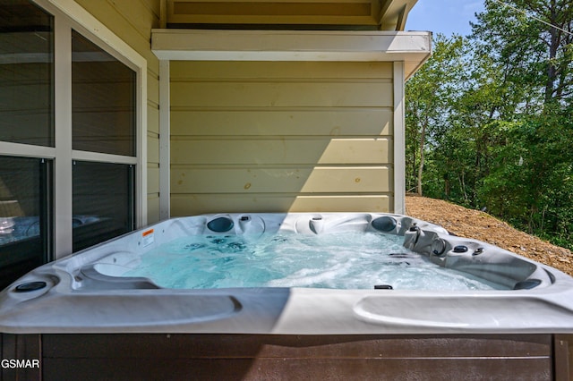 exterior details featuring washer / dryer and a hot tub