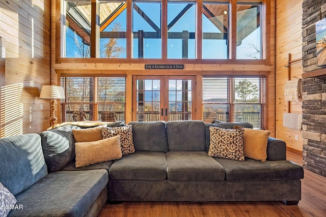 2229 Legend Dr, Sevierville, TN 37876 - living area featuring wooden walls, hardwood / wood-style flooring, a towering ceiling, and french doors