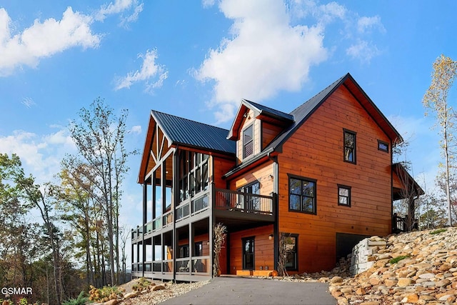 2229 Legend Dr, Sevierville, TN 37876 - view of side of property featuring asphalt driveway, a garage, a metal roof, and a wooden deck