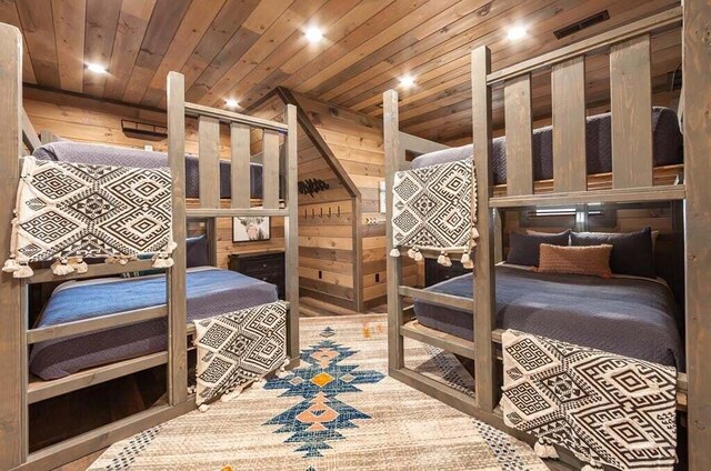 bedroom with wooden ceiling and wooden walls