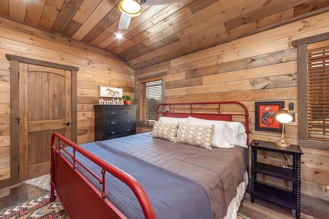 bedroom featuring wood walls, ceiling fan, wood ceiling, and vaulted ceiling