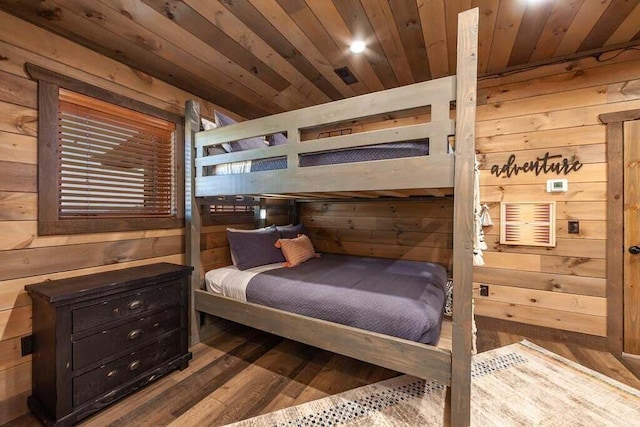 bedroom with hardwood / wood-style flooring, wood walls, and wood ceiling