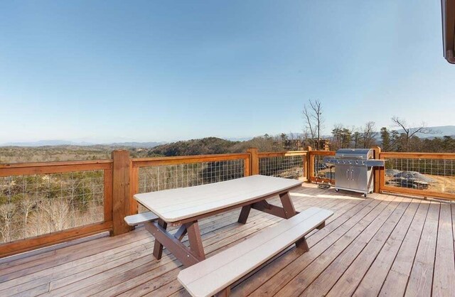 wooden deck featuring area for grilling