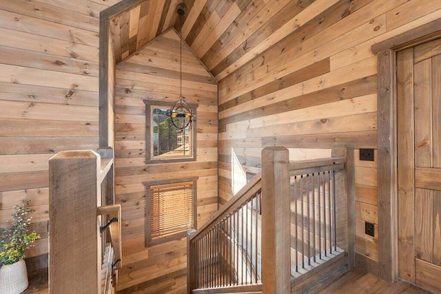 interior space with wood walls, lofted ceiling, and wooden ceiling