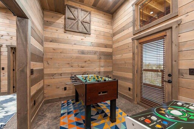 playroom featuring wooden walls and wood ceiling