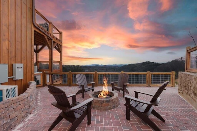 patio terrace at dusk featuring an outdoor fire pit