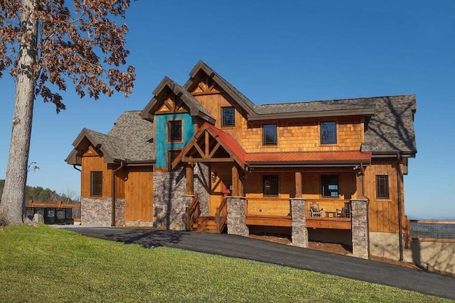 view of front of house with a porch and a front lawn