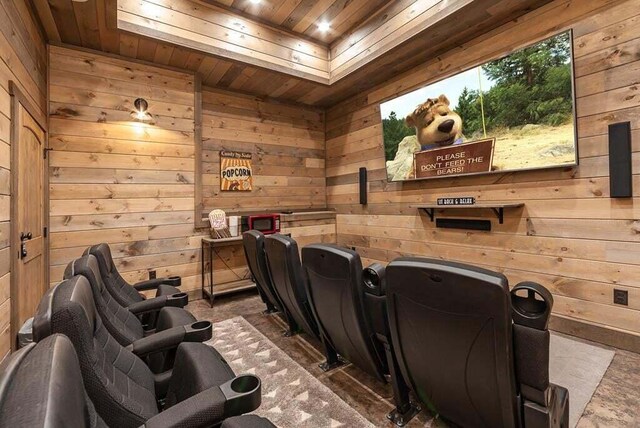 home theater with wooden ceiling and wood walls