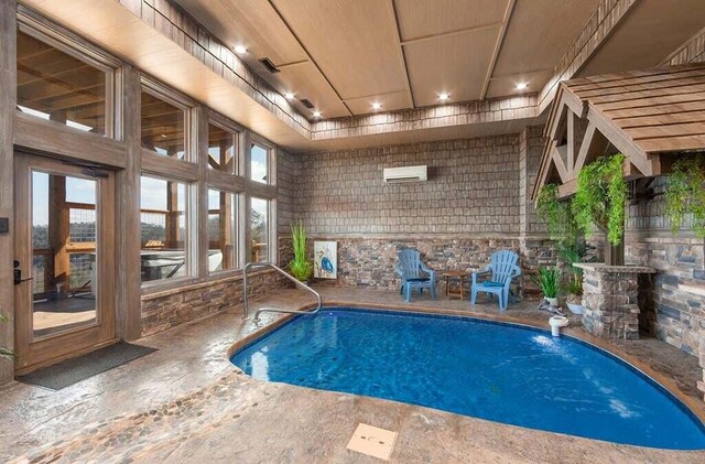 view of pool featuring a patio area and an AC wall unit