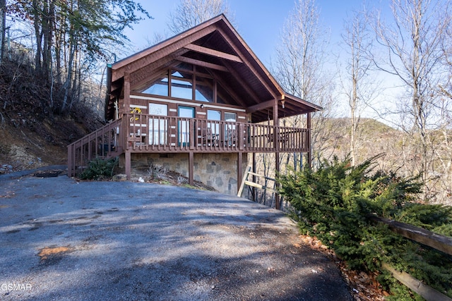 rear view of property featuring a deck