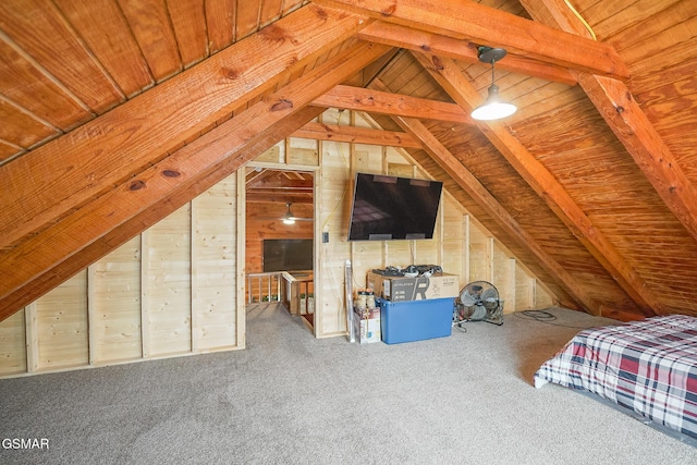 unfurnished bedroom with vaulted ceiling, carpet flooring, and wood walls