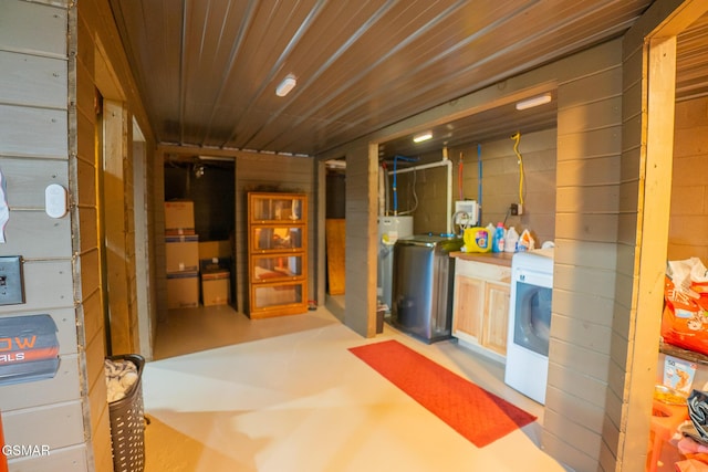 unfinished basement with washer / dryer, wood ceiling, and water heater