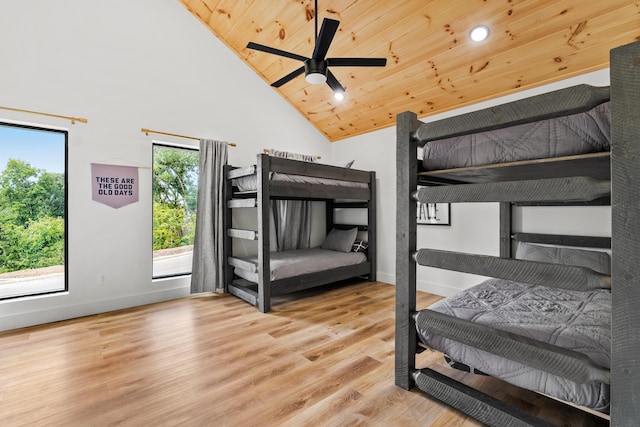 bedroom with hardwood / wood-style flooring, high vaulted ceiling, and wooden ceiling