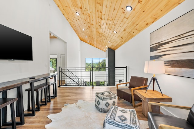 living area featuring high vaulted ceiling, wooden ceiling, and light hardwood / wood-style floors