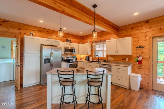 810 Kings Way, Gatlinburg, TN 37738 - kitchen with stainless steel appliances, washer / dryer, a sink, white cabinetry, and wood finished floors