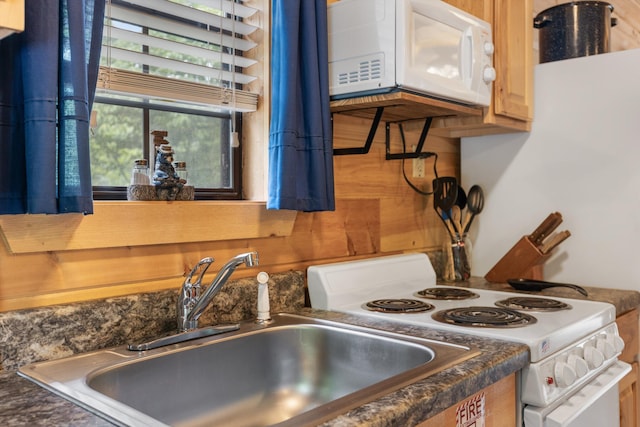 kitchen featuring sink and white appliances