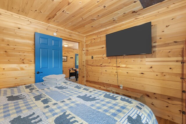 bedroom with wooden walls and wood ceiling