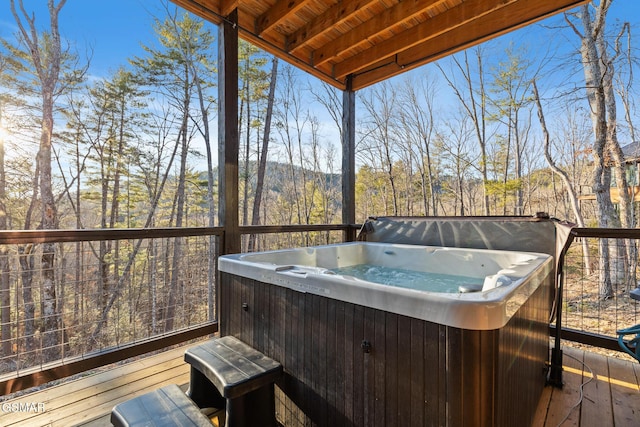 sunroom with a hot tub