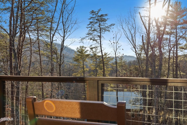 wooden deck with a mountain view and a forest view