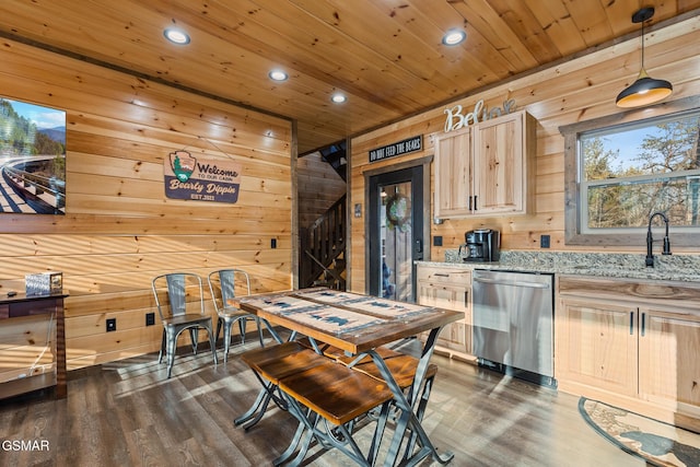 kitchen with light brown cabinetry, wood ceiling, a sink, wooden walls, and dishwasher