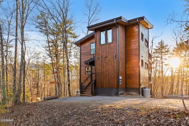 view of outdoor structure with entry steps and driveway